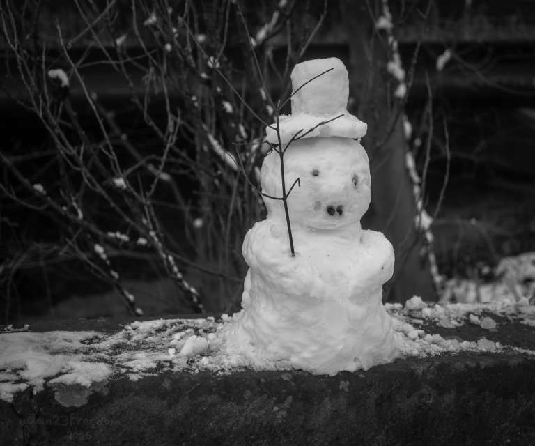 A charming winter greeting from a minimalist snowperson, inviting warmth and whimsy amid the cold. — Snow smiles softly, / Tiny hat tips to the breeze, / Winter’s quiet friend.